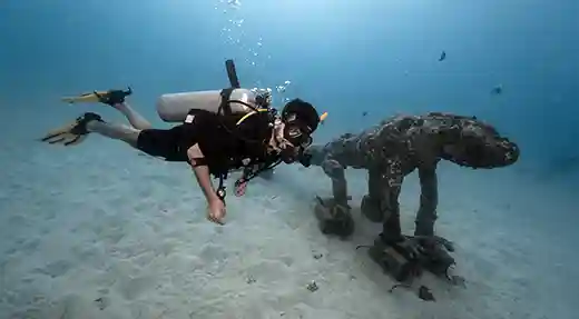 Exploring an Artificial Reef in Koh Tao Diver exploring an elephant-shaped artificial reef sculpture in Koh Tao