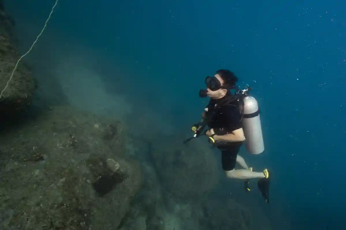Controlled Buoyancy Beside the Reef Diver maintaining controlled buoyancy beside a reef wall in Koh Tao