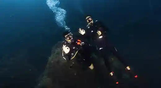 Fun Diving in Koh Tao with Flow Divers Two certified divers giving the OK sign during a fun dive at a wreck site in Koh Tao