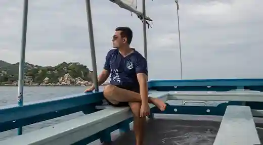 PADI Nitrox Course Diver on the Boat Diver relaxing on the Flow Divers boat during a PADI Nitrox course in Koh Tao