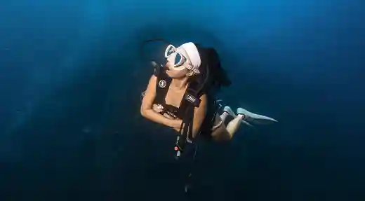 PADI Advanced Open Water Course in Koh Tao Female diver hovering underwater during the PADI Advanced Open Water Course in Koh Tao