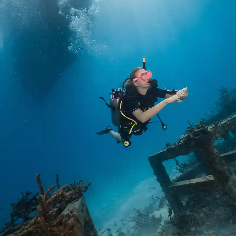 PADI Open Water Course Artificial Reef Dive in Koh Tao Open Water student swimming above an artificial reef during a training dive in Koh Tao