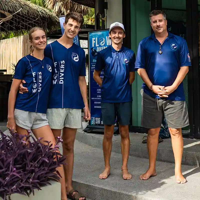 Meet Your PADI Open Water Course Team in Koh Tao Flow Divers team outside the dive centre during a PADI Open Water Course in Koh Tao