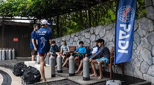 PADI Scuba Diver Poolside Preparation in Koh Tao Instructor briefing students beside the pool before PADI Scuba Diver training in Koh Tao