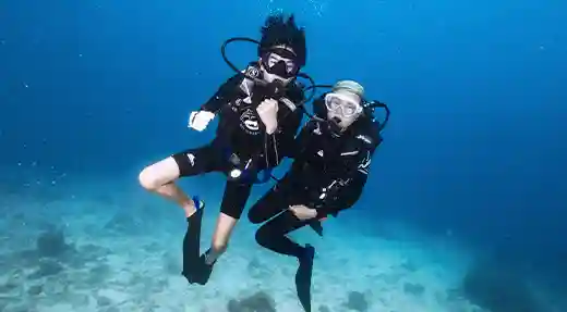 Supported PADI Scuba Diver Training Dive in Koh Tao Instructor and student swimming together during a PADI Scuba Diver training dive in Koh Tao