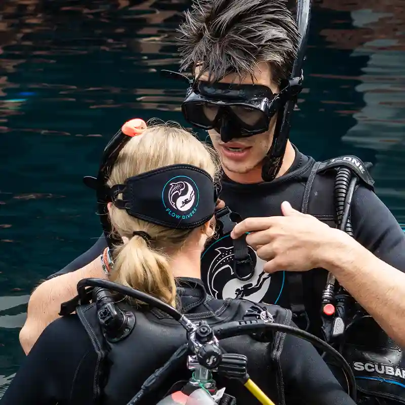 Scuba Refresher Pool Session Koh Tao | Flow Divers Flow Divers instructor helping a certified diver during a scuba refresher pool session in Koh Tao