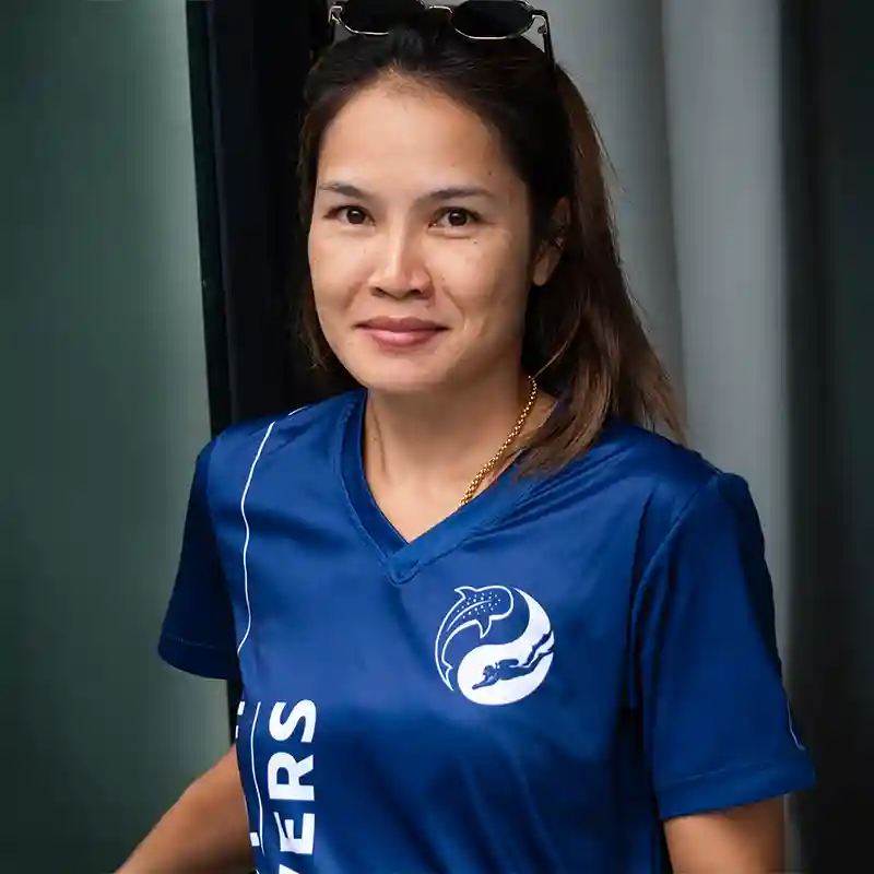 Tangmay, co-owner of Flow Divers Koh Tao, wearing a Flow Divers shirt