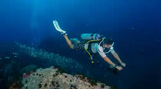 Underwater Photography on a Deep Dive | Flow Divers Scuba diver taking underwater photographs during a deep dive in Koh Tao