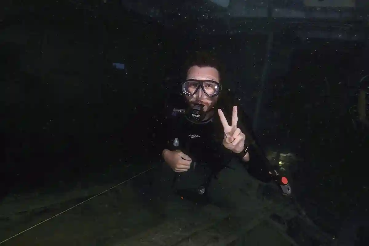 Wreck Penetration Dive in Koh Tao Scuba diver following a guideline inside a shipwreck during wreck diving in Koh Tao